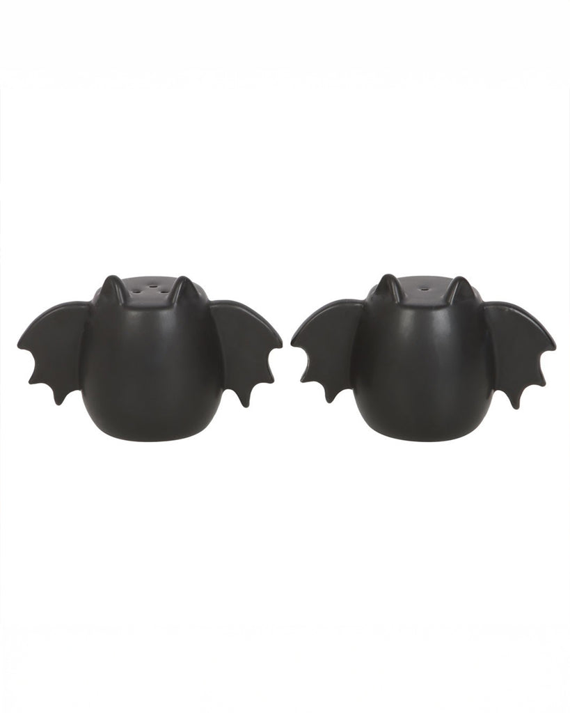 A gothic-themed set of salt and pepper shakers shaped like bats, crafted from ceramic with a sleek black finish. A fun and functional piece of tableware.