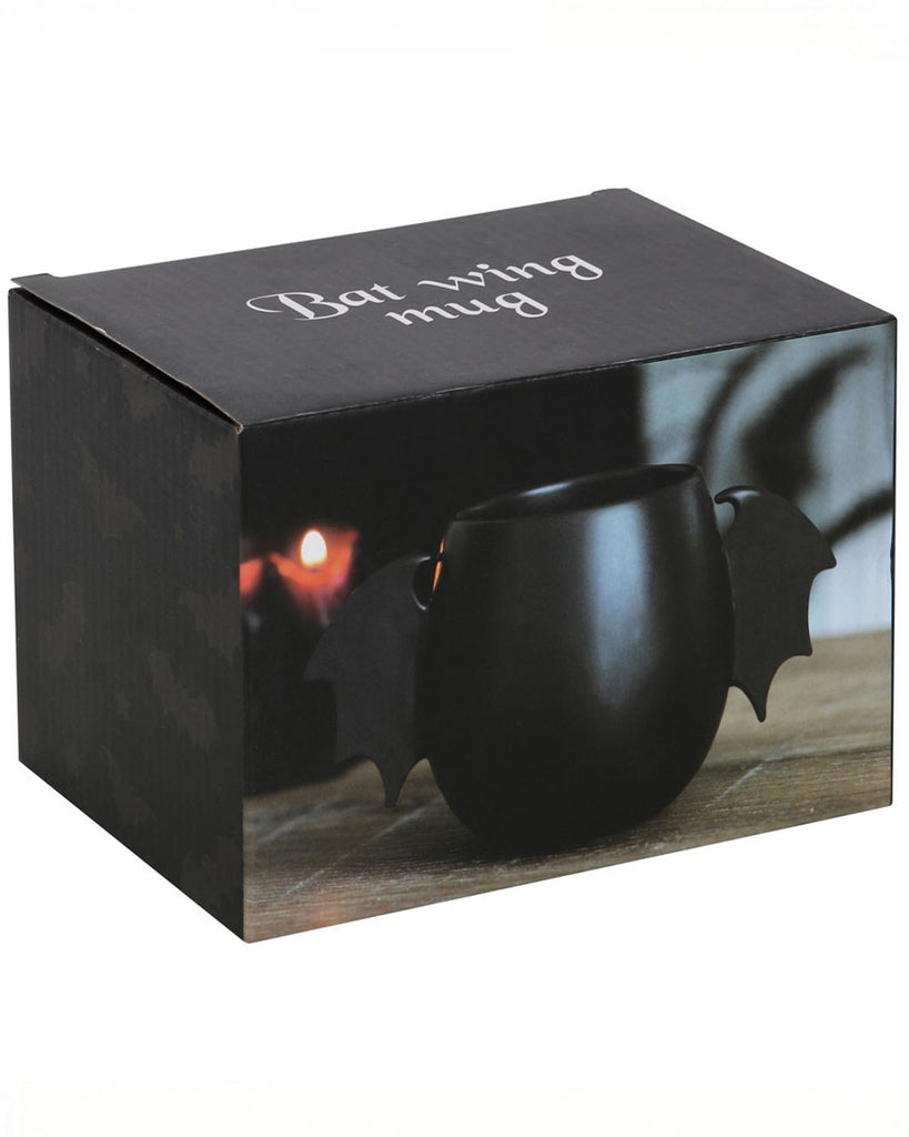 Product packaging for the Bat Wing Mug, featuring an image of the mug lit by candlelight with “Bat wing mug” text in a gothic font. Ideal for gifting and spooky homeware collections.