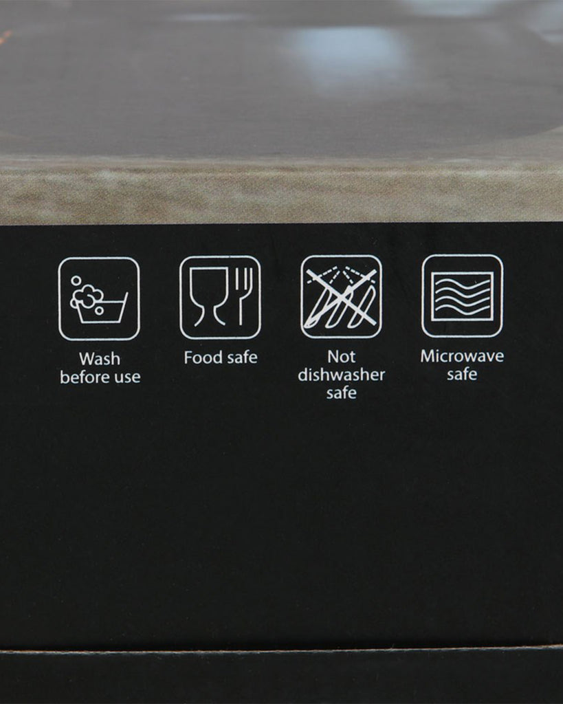 Close-up of care instructions on the box: wash before use, food safe, not dishwasher safe, microwave safe. Icons are white on a black background for clear guidance on how to use the bat wing mug safely.