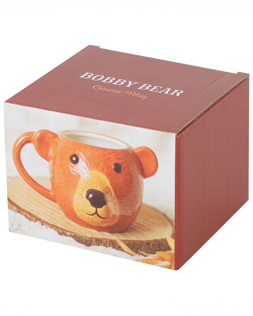 Packaging for the Rebel Romance Bobby Bear Ceramic Mug, featuring the mug on a wood slice with autumn decor. The box showcases the bear face design and makes it ready-to-gift.