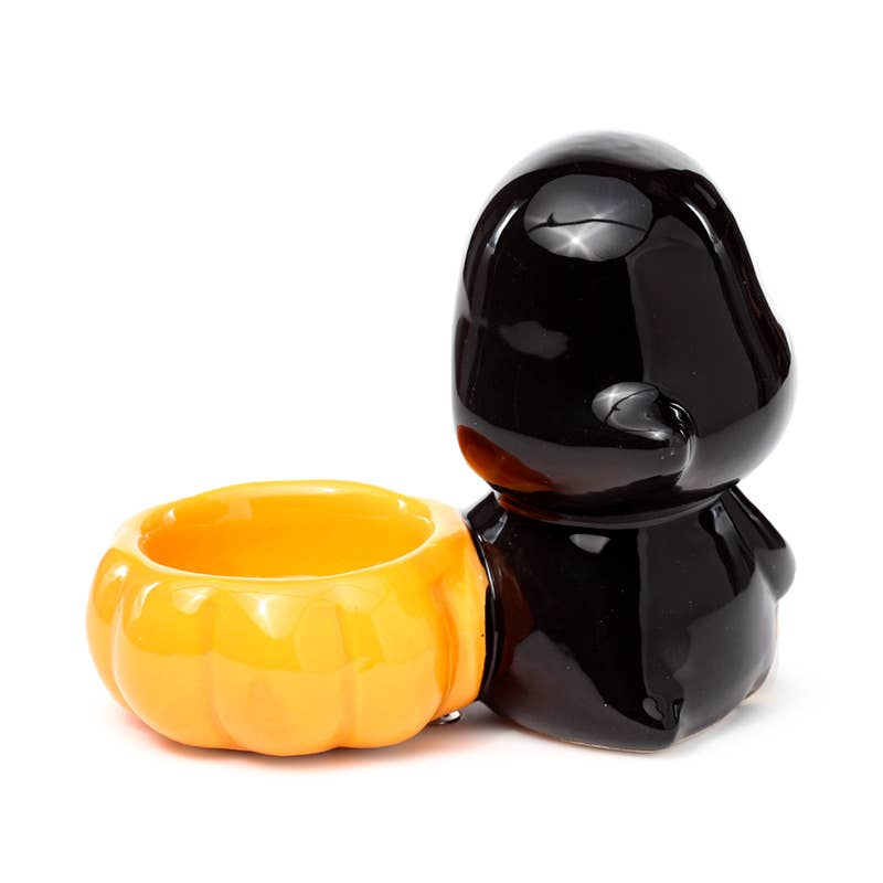 Back view of the Ceramic Skull Boy Tea Light Holder, showing the smooth black hooded figure with a pumpkin-shaped bowl for a tea light candle. A quirky autumnal piece by Rebel Romance, a UK brand for alternative aesthetics.