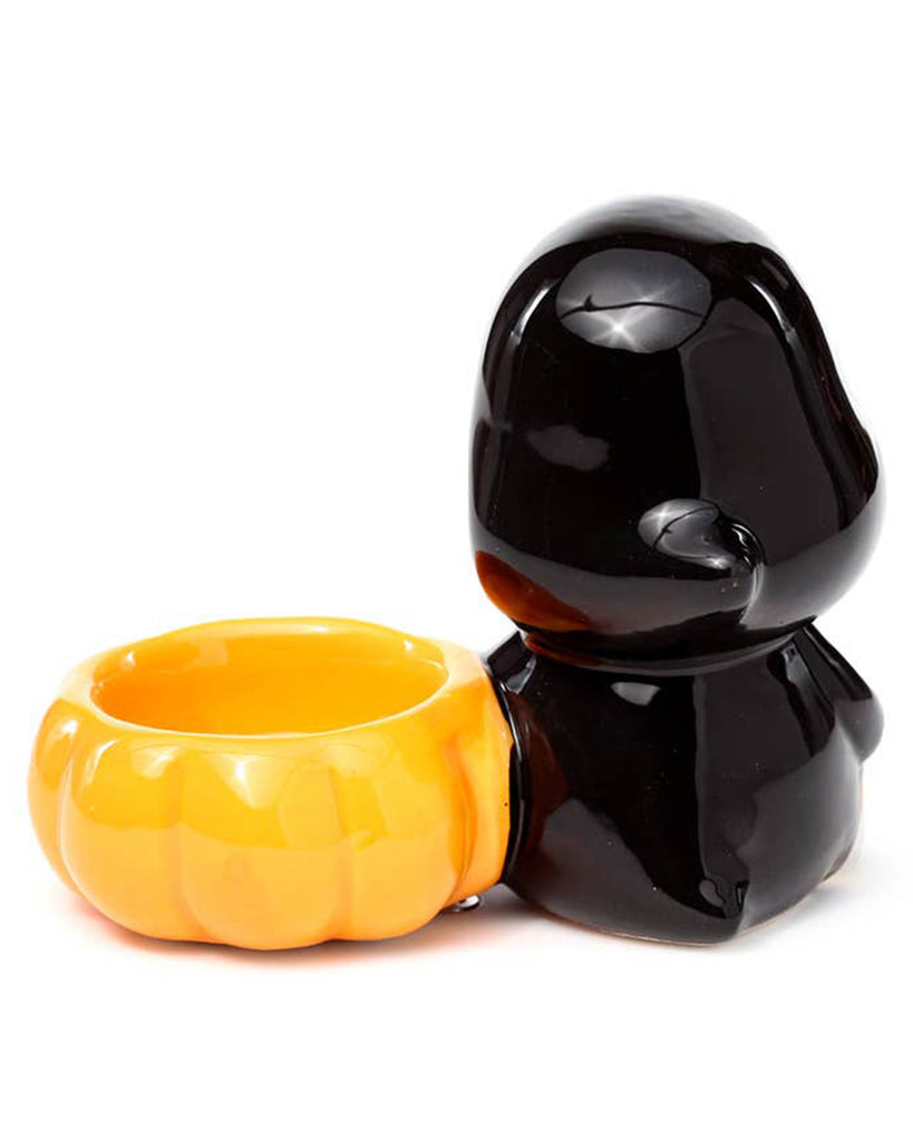 Back view of the Ceramic Skull Boy Tea Light Holder, showing the smooth black hooded figure with a pumpkin-shaped bowl for a tea light candle. A quirky autumnal piece by Rebel Romance, a UK brand for alternative aesthetics.