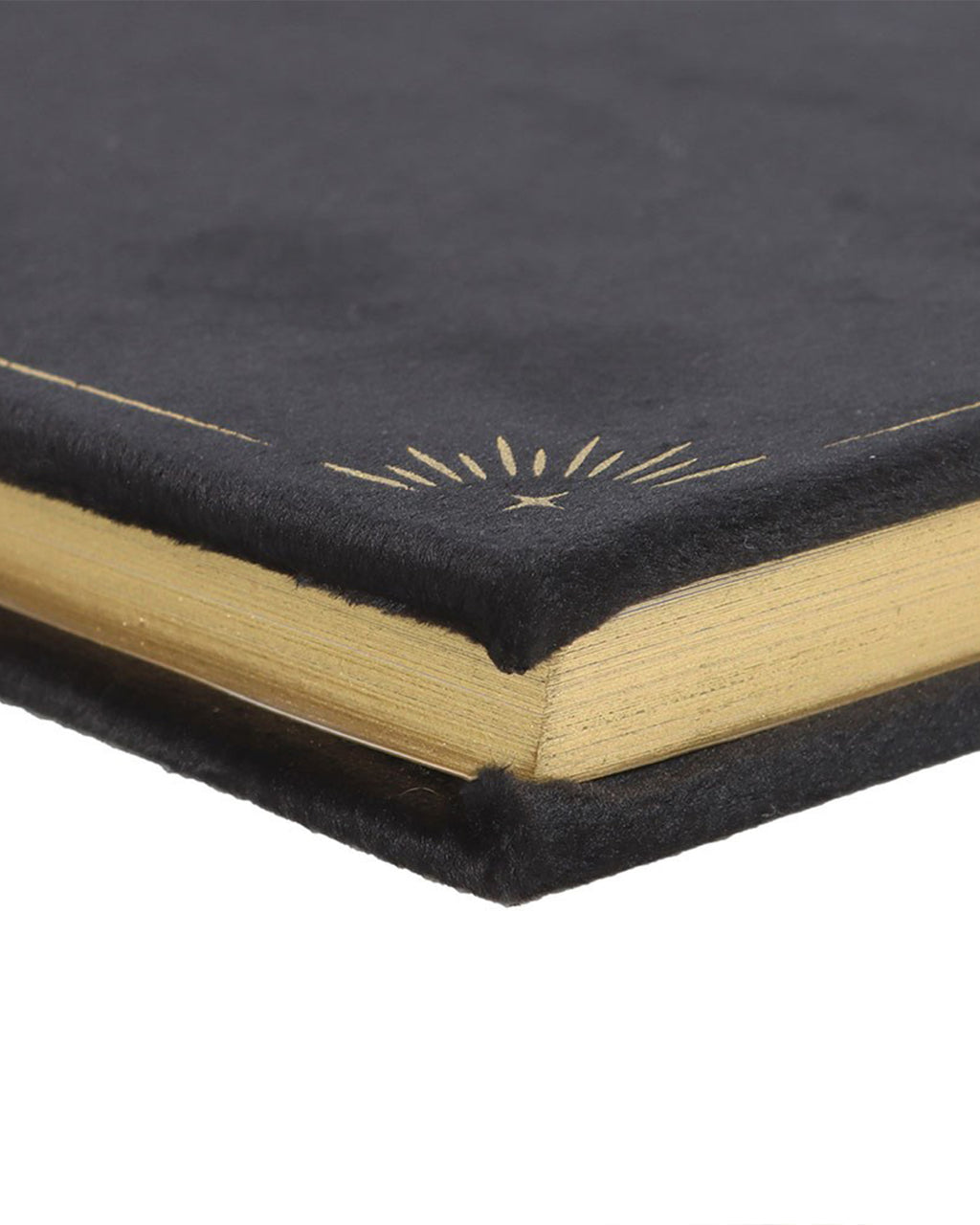Close-up of the Book of Shadows journal corner, showing the plush black velvet cover with gold sunburst detailing. The journal's gold-edged pages shimmer, adding a luxurious touch to this witchy stationery piece.