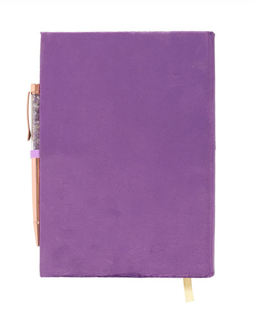 Back view of the Book of Spells journal by Rebel Romance. The plain purple velvet cover includes a built-in elastic pen holder and a satin ribbon page marker for easy note-keeping.