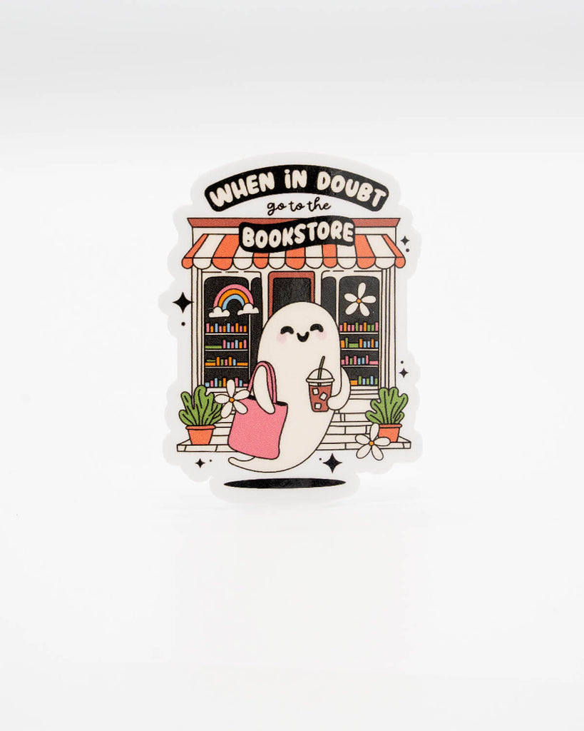 Cute vinyl die-cut sticker featuring a happy ghost holding iced coffee and a tote bag, standing outside a colourful bookshop. Text reads “When in doubt, go to the bookstore.” A playful bookish decal for readers and ghost lovers alike. Designed by Rebel Romance, a small UK brand known for celebrating alternative style, whimsical gifts, and millennial-friendly aesthetics.