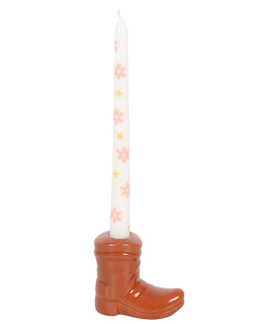 Close-up of the Rebel Romance brown ceramic cowboy boot candle holder, holding a floral and star-print white taper candle. The boot is glossy brown, designed to resemble a classic western cowboy boot with charming retro details.