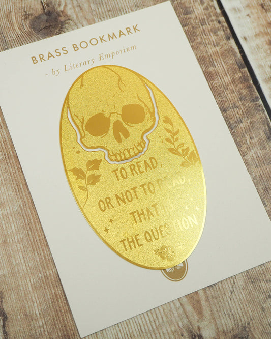 Close‑up of the Shakespeare Hamlet Skull Brass Bookmark on backing card. A Literary Emporium design sold by Rebel Romance, a UK small business offering gothic gifts, homeware and slow ethical fashion.