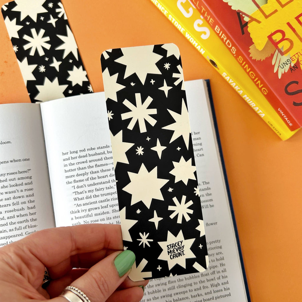Discover the Bats Bookmark – a gothic Halloween-inspired accessory featuring a spooky bats and stars design by Stacey McEvoy Caunt. Luxurious velvet matte finish, 14.8 x 5.2 cm, and professionally printed in the UK. Perfect for book lovers and spooky season enthusiasts!