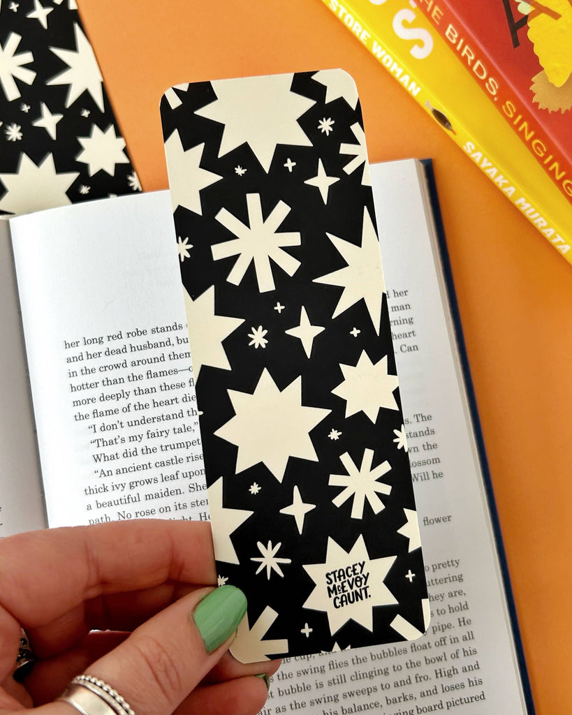 Discover the Bats Bookmark – a gothic Halloween-inspired accessory featuring a spooky bats and stars design by Stacey McEvoy Caunt. Luxurious velvet matte finish, 14.8 x 5.2 cm, and professionally printed in the UK. Perfect for book lovers and spooky season enthusiasts!