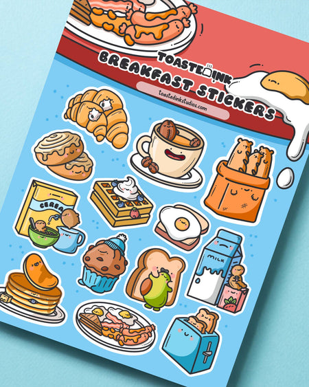 Adorable breakfast sticker sheet by Toastedink, stocked at Rebel Romance. Features cartoon-style breakfast foods like croissants, waffles, eggs and toast. Great for decorating planners, scrapbooks and gifts with a playful foodie twist.