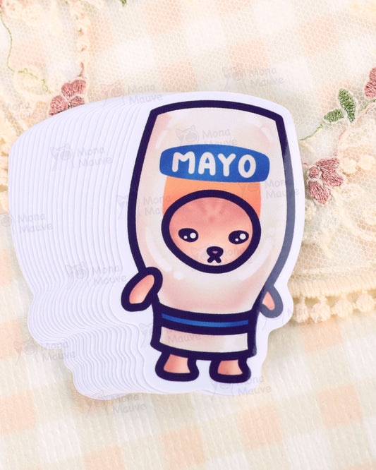Stack of Rebel Romance Mayo Cat vinyl stickers by Mona Mauve, featuring a cartoon cat inside a squeezable mayonnaise bottle costume from the Snack Cats collection. Printed on waterproof, durable vinyl with a soft pastel colour palette. Perfect for decorating water bottles, laptops, or gifting to quirky food lovers and kawaii stationery fans. Displayed on vintage lace and gingham fabric background.