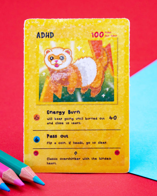 ADHD collectable trading card sticker designed by Innabox, featuring a sparkly gloss finish and a playful ferret character bursting with energy. The waterproof vinyl sticker includes humorous traits like “Energy Burn” and “Pass Out.” A fun neurodivergent-themed design, perfect for laptops, water bottles, or journals. 