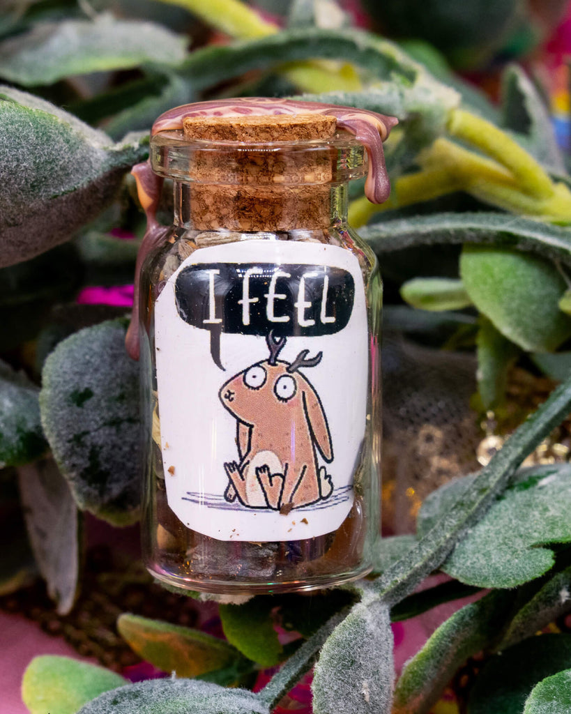A magical spell bottle by Happiness Enchanters with a wax-sealed cork and a label showing a soft brown jackalope with the affirmation “I Feel”. Available at Rebel Romance, a small UK business offering alternative fashion, gifts, and mystical treasures.