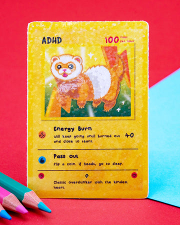 ADHD collectable trading card sticker designed by Innabox, featuring a sparkly gloss finish and a playful ferret character bursting with energy. The waterproof vinyl sticker includes humorous traits like “Energy Burn” and “Pass Out.” A fun neurodivergent-themed design, perfect for laptops, water bottles, or journals. 