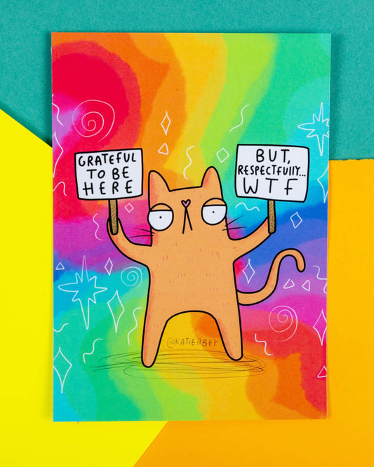 Bright rainbow postcard from Rebel Romance featuring a cartoon orange cat holding two signs. One sign says “Grateful to be here” and the other reads “But, respectfully… WTF”. The design is quirky, colourful, and illustrated by Katie Abey. Ideal for alternative stationery lovers looking for something sassy and relatable. A fun gift or art piece for cat fans, millennials, and lovers of bold, expressive design.