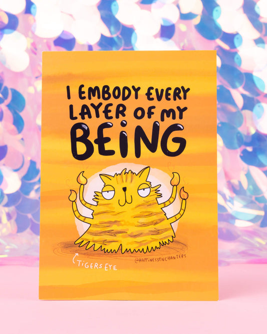 Vibrant orange postcard from Rebel Romance featuring a quirky tiger-striped cat with six flame arms, surrounded by golden tones and radiating confidence. Text reads, “I embody every layer of my being.” A playful design by Katie Abey for Happiness Enchanters, inspired by the Tigers Eye crystal.