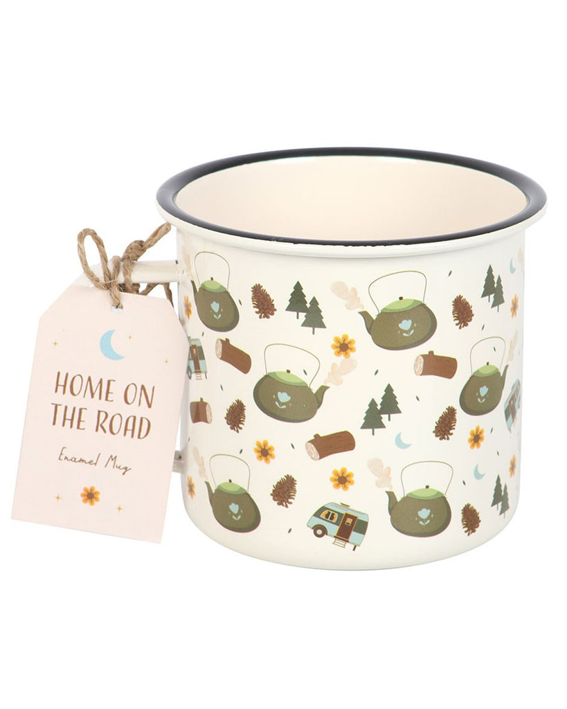 Cream enamel camping mug with black rim, featuring a whimsical print of green kettles, pine trees, caravans, logs, pinecones, and flowers, with a gift tag that reads "Home On The Road."