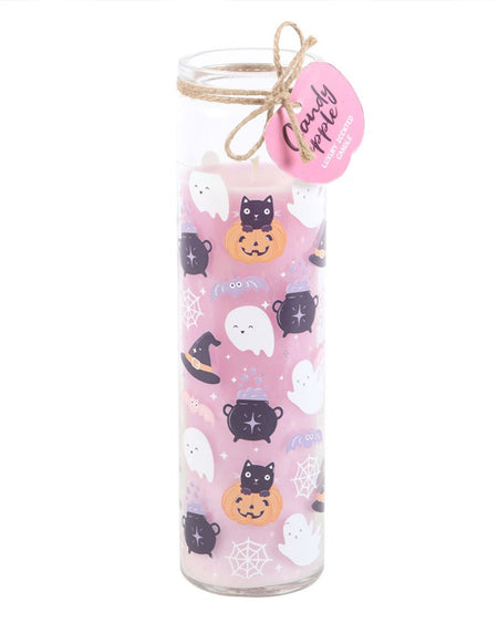 The Pastel Halloween Candy Apple Tube Candle with its pink pumpkin-shaped tag reading "Candy Apple Luxury Scented Candle." The glass holder showcases the whimsical pastel design with cauldrons, bats, spider webs, and happy ghost faces.