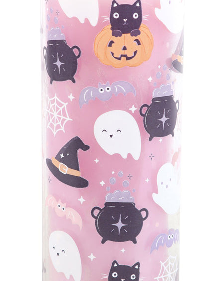 A close-up of the Pastel Halloween Candy Apple Tube Candle by Rebel Romance. The candle is pink with a cute Halloween print, including black cats, ghosts, cauldrons, witch hats, bats, and spider webs. The design is playful and pastel-themed, perfect for spooky season lovers.