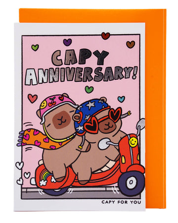 Whimsical Capy Anniversary card from Rebel Romance showing two capybaras cuddled up on a scooter under silver foil text reading “Capy Anniversary!” Adorned with colourful hearts on a pink background, this playful card is ideal for anniversaries, especially for couples who love cute animals and fun, offbeat stationery.