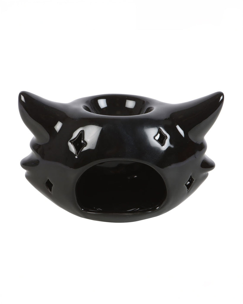 Back view of the ceramic black cat oil burner, showing a cutout for placing a tealight candle. Star-shaped eye holes allow light to shine through when lit, adding an eerie glow.