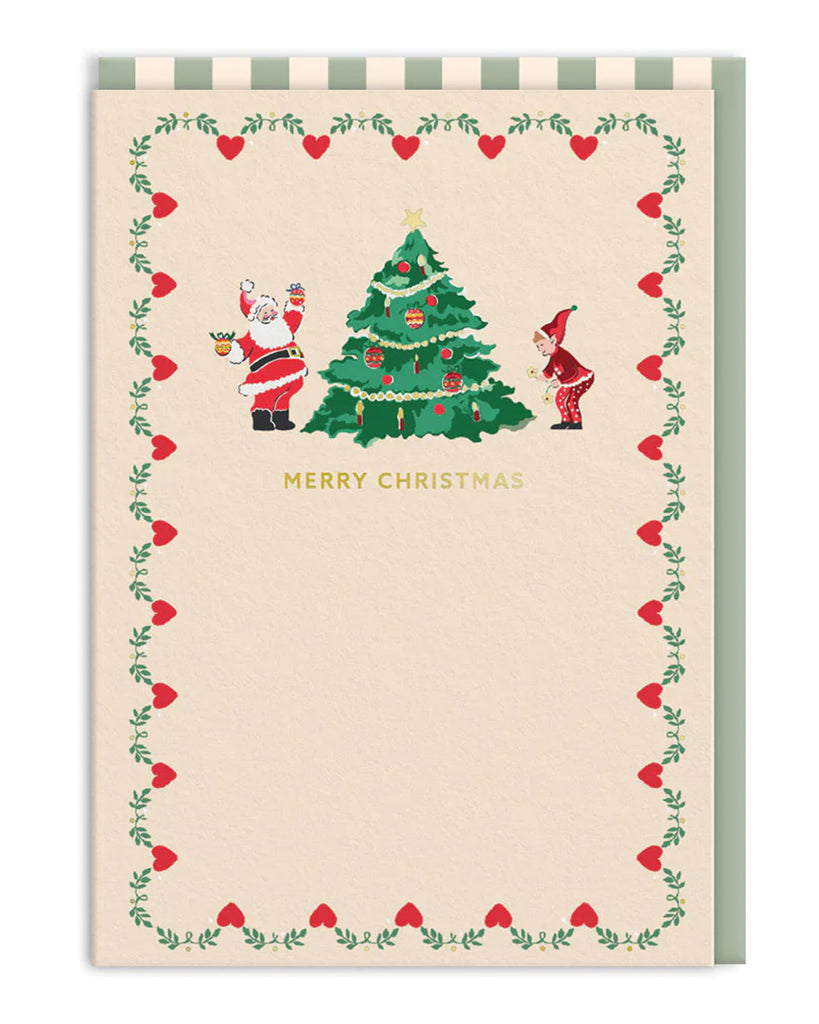 Inside view of Cath Kidston Christmas card with Santa, elf, tree, and “Merry Christmas” message framed by red hearts and green garlands. Stocked by Rebel Romance, perfect for alternative festive cheer.
