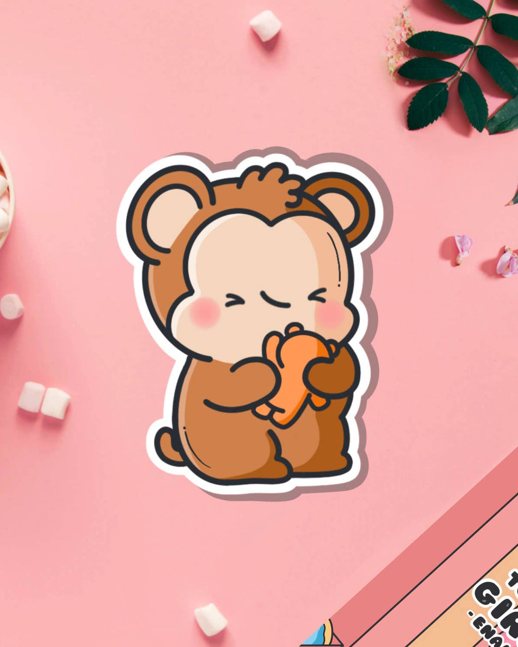 Sweet monkey hugging teddy bear vinyl sticker from Toastedink, styled on a pink background with mini marshmallows and leaves. Stocked by Rebel Romance, a UK brand for millennials who love cute, quirky, and unusual designs.