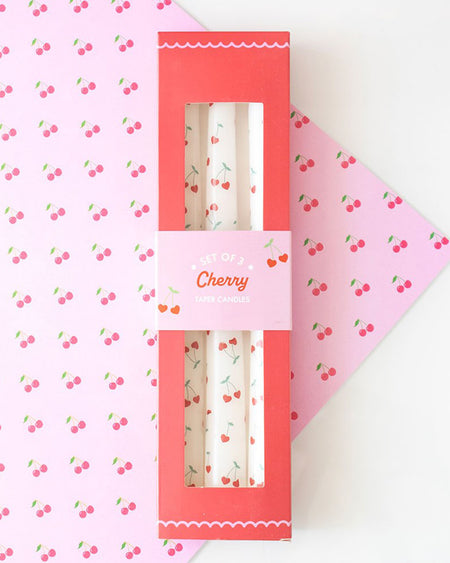 Flat lay of the Rebel Romance Lovestruck collection, featuring the Heart Cherry Taper Candles alongside other Valentine's-themed homeware and gifts. The collection’s retro-inspired design and bold pink and red tones create a fun, romantic vibe.