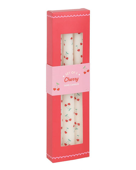  Front-facing view of the Rebel Romance Heart Cherry Taper Candles in their original red and pink packaging. The cut-out window displays the candles' cherry heart design, while the scalloped edges and cute illustrations highlight the Lovestruck collection.
