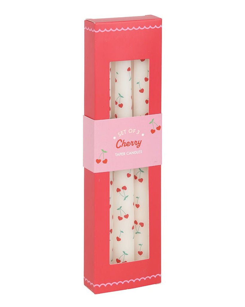  Front-facing view of the Rebel Romance Heart Cherry Taper Candles in their original red and pink packaging. The cut-out window displays the candles' cherry heart design, while the scalloped edges and cute illustrations highlight the Lovestruck collection.