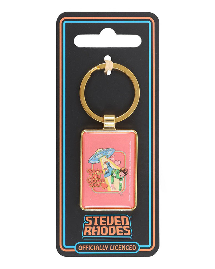 Steven Rhodes “You’re My Chosen One!” keyring on official branded backing card, sold by Rebel Romance. Retro pink enamel design with UFO and hearts, framed in gold. A unique and playful gift for fans of kitsch, alternative, and vintage-style accessories.