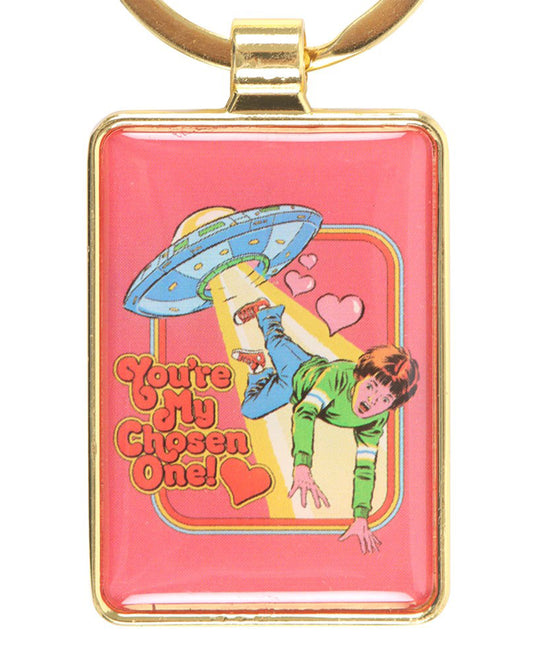 Rebel Romance officially licensed Steven Rhodes keyring featuring a retro pink design with a cartoon UFO abducting a surprised child surrounded by hearts and the words “You’re My Chosen One!” framed in gold. A quirky accessory for alternative fashion lovers and unique gift seekers.