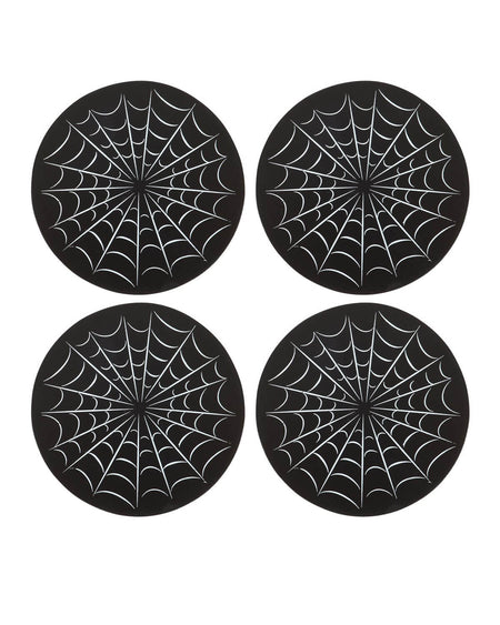  Close-up of four round black coasters with white spiderweb designs, laid flat in a group.