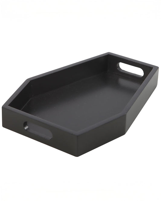 Angled view of a plain black coffin-shaped trinket tray made from MDF, with cut-out handles on each side. A gothic home accessory by Rebel Romance, perfect for displaying candles, jewellery, or small items.