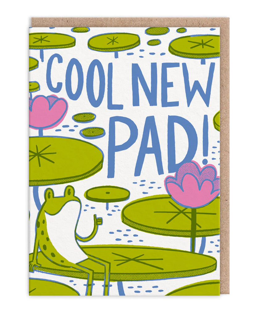 A colourful illustrated greeting card featuring a smiling green frog sitting on a lily pad, giving a thumbs up. Surrounded by bright green lily pads and pink water lilies, the card reads “Cool New Pad!” in large blue text. Designed by Hello!Lucky and sold by Rebel Romance, a small UK business that celebrates quirky, retro-inspired designs. Perfect for congratulating someone on their new home.