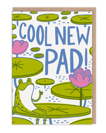 A colourful illustrated greeting card featuring a smiling green frog sitting on a lily pad, giving a thumbs up. Surrounded by bright green lily pads and pink water lilies, the card reads “Cool New Pad!” in large blue text. Designed by Hello!Lucky and sold by Rebel Romance, a small UK business that celebrates quirky, retro-inspired designs. Perfect for congratulating someone on their new home.