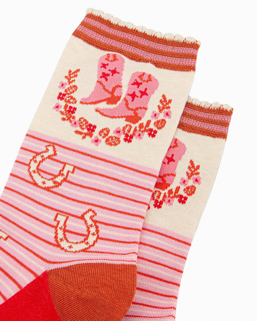 (Close-Up of Design): A detailed close-up of the bamboo cowboy socks, showing the intricate stitched cowboy boot pattern, floral wreaths, and the striped cuff with a scalloped edge for extra detail.
