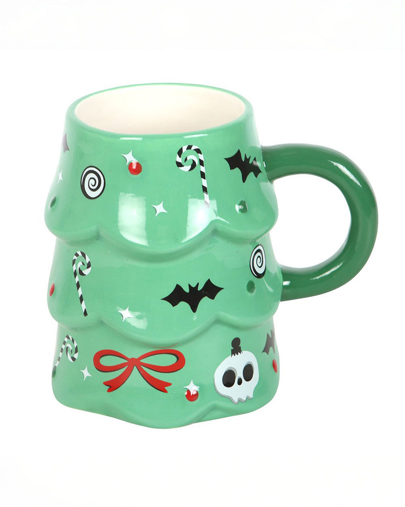 A green ceramic Christmas tree mug from Rebel Romance, decorated with creepy black bats, white skulls, red bows and candy canes. The mug has a fun alternative festive design with a smooth glazed finish and a large green handle.