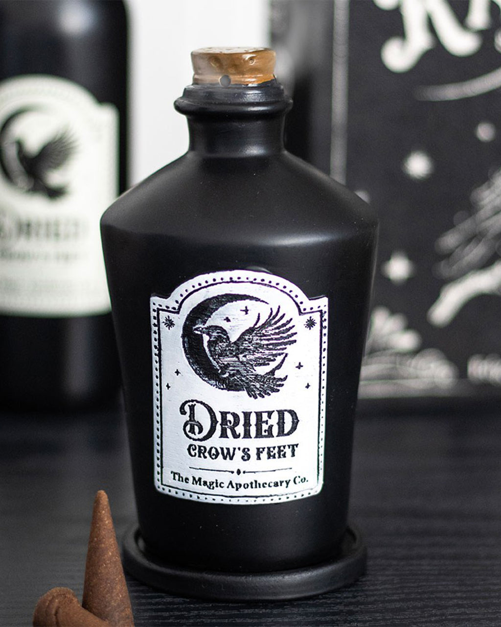 Stylised image of the Dried Crow’s Feet incense holder by Rebel Romance, showing label detail and cone placement— ideal gothic decor for millennials who love the mystical.