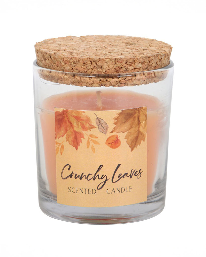 A side view of the Rebel Romance Crunchy Leaves candle with the cork lid placed on top. The soft amber wax complements the autumnal label design, making it a stylish addition to any cosy setting.