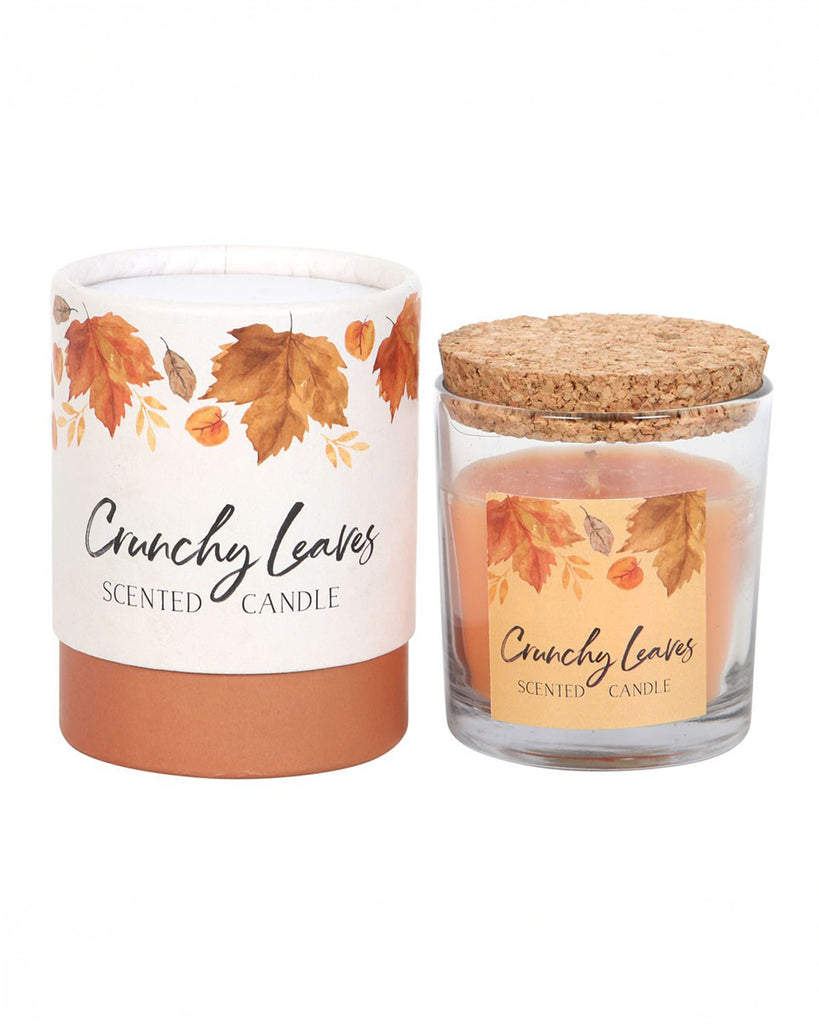 A beautifully styled shot of the Rebel Romance Crunchy Leaves candle and its packaging, placed side by side. The warm autumn leaf design and eco-friendly cork lid make this a charming seasonal addition to any home.