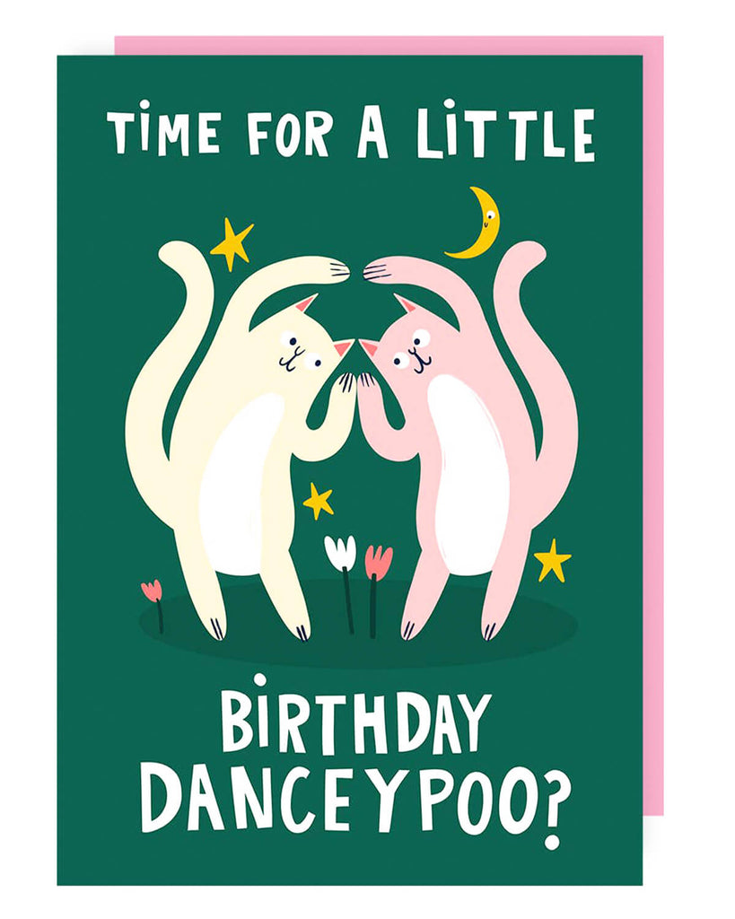 A dark green birthday card featuring two dancing cats, one cream and one pink, surrounded by stars, tulips, and a crescent moon. The words “TIME FOR A LITTLE BIRTHDAY DANCEYPOO?” are written in bold white letters. A pink envelope is included.
