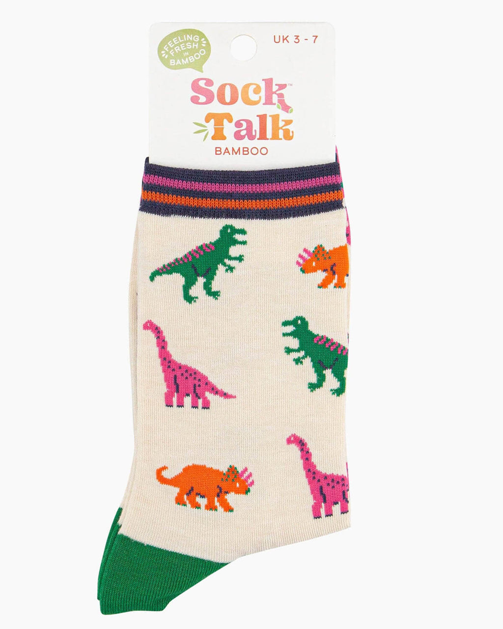 A pair of cream bamboo socks with a playful dinosaur print featuring green T-Rex, pink brachiosaurus, and orange triceratops, finished with contrasting pink toes, green heels, and a striped cuff.