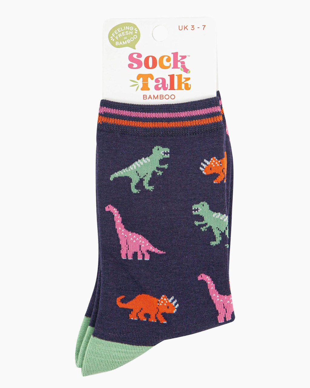  A pair of navy blue bamboo socks folded inside their Sock Talk packaging. The socks feature a colourful dinosaur pattern, including green T-Rex, pink Brachiosaurus, and orange Triceratops. The packaging label states “Feeling Fresh Bamboo” and indicates a UK 3-7 size range.