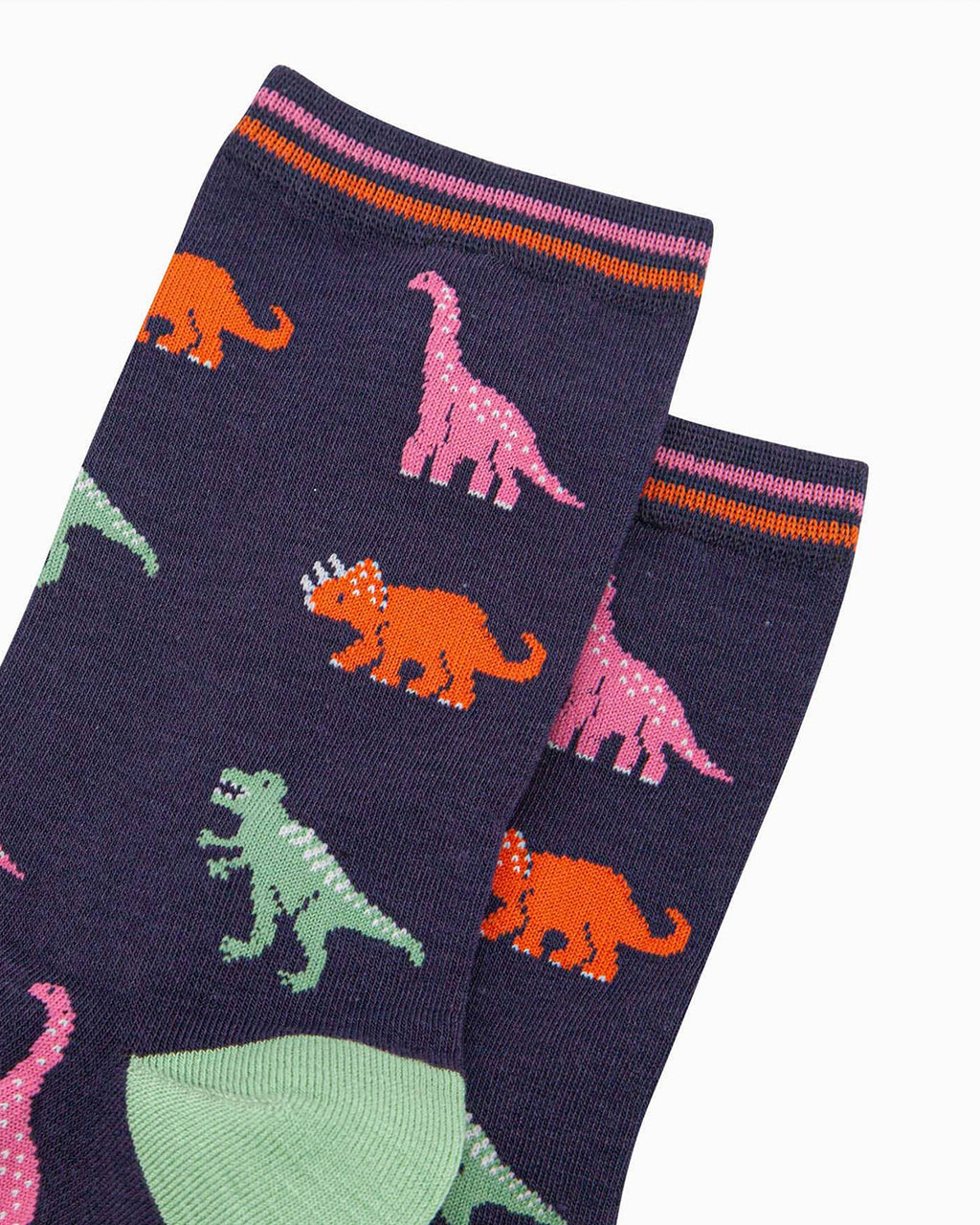 (Close-Up of Socks): A detailed close-up of the bamboo socks, showing the pixel-style dinosaur print in pink, orange, and green against the navy background. The ribbed striped cuff adds a finishing touch.
