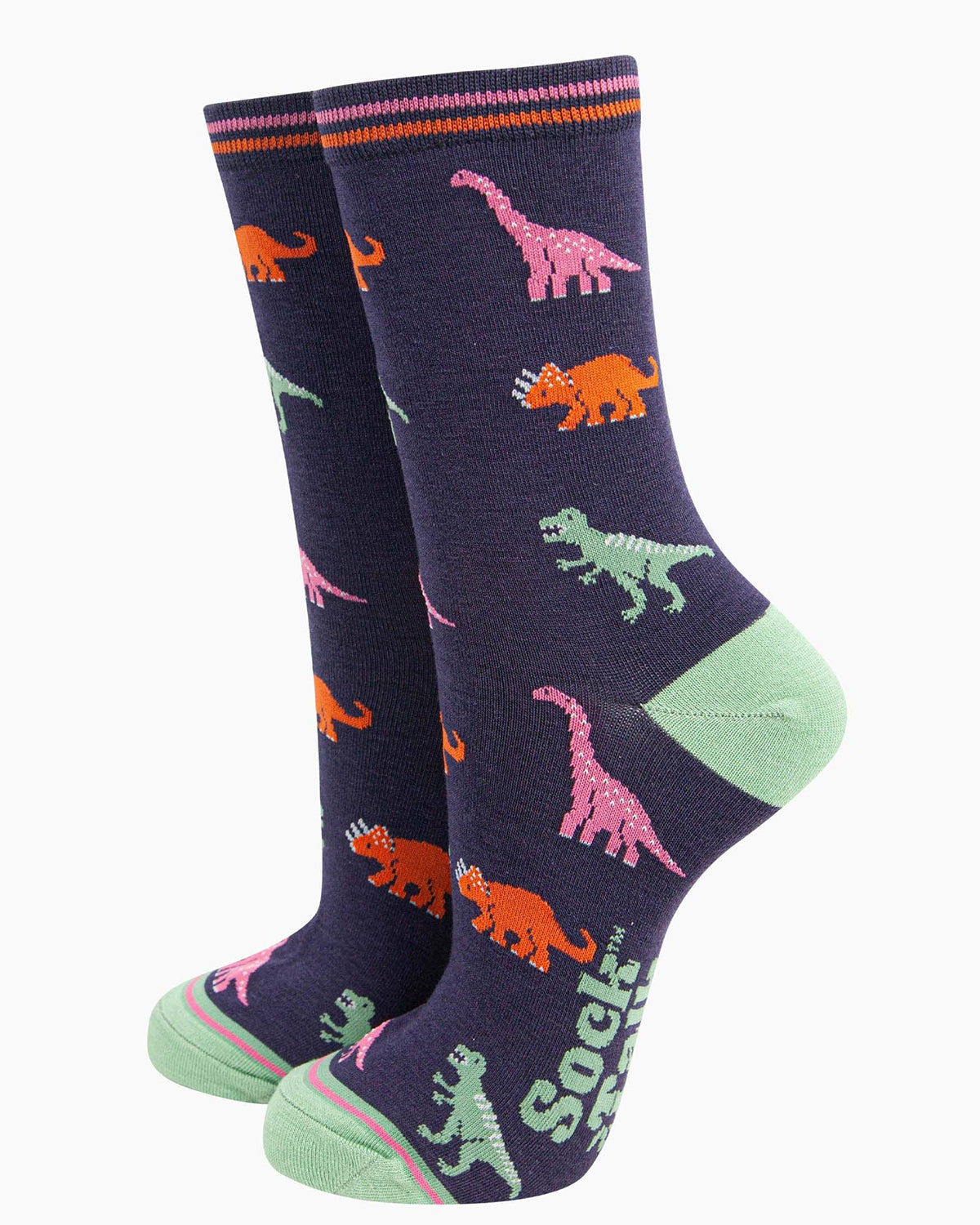 Socks Standing Up): A pair of bamboo dinosaur socks displayed upright, highlighting their mid-calf length and stretchy fit. The contrasting green heel and toe, plus the striped cuff, add a stylish finish to the prehistoric print.
