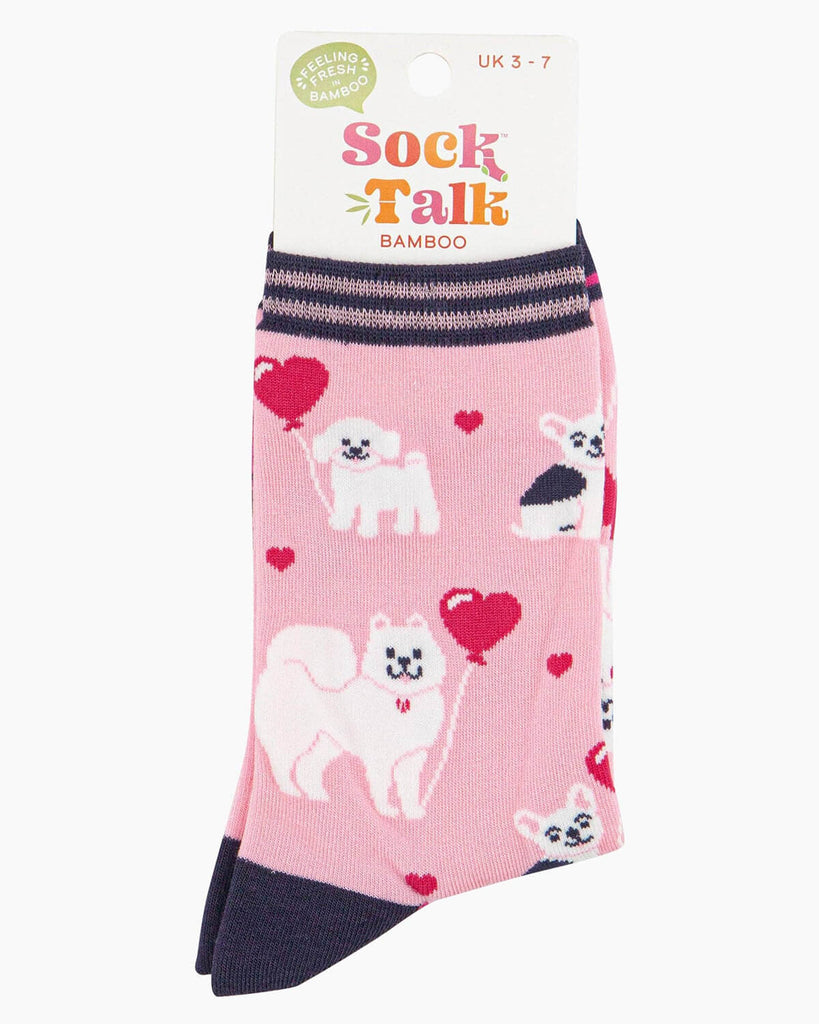 (Packaged Socks): A folded pair of bamboo dog socks inside their Sock Talk bamboo packaging, showcasing the cute dog and heart balloon design. The packaging states a UK 3-7 size range.