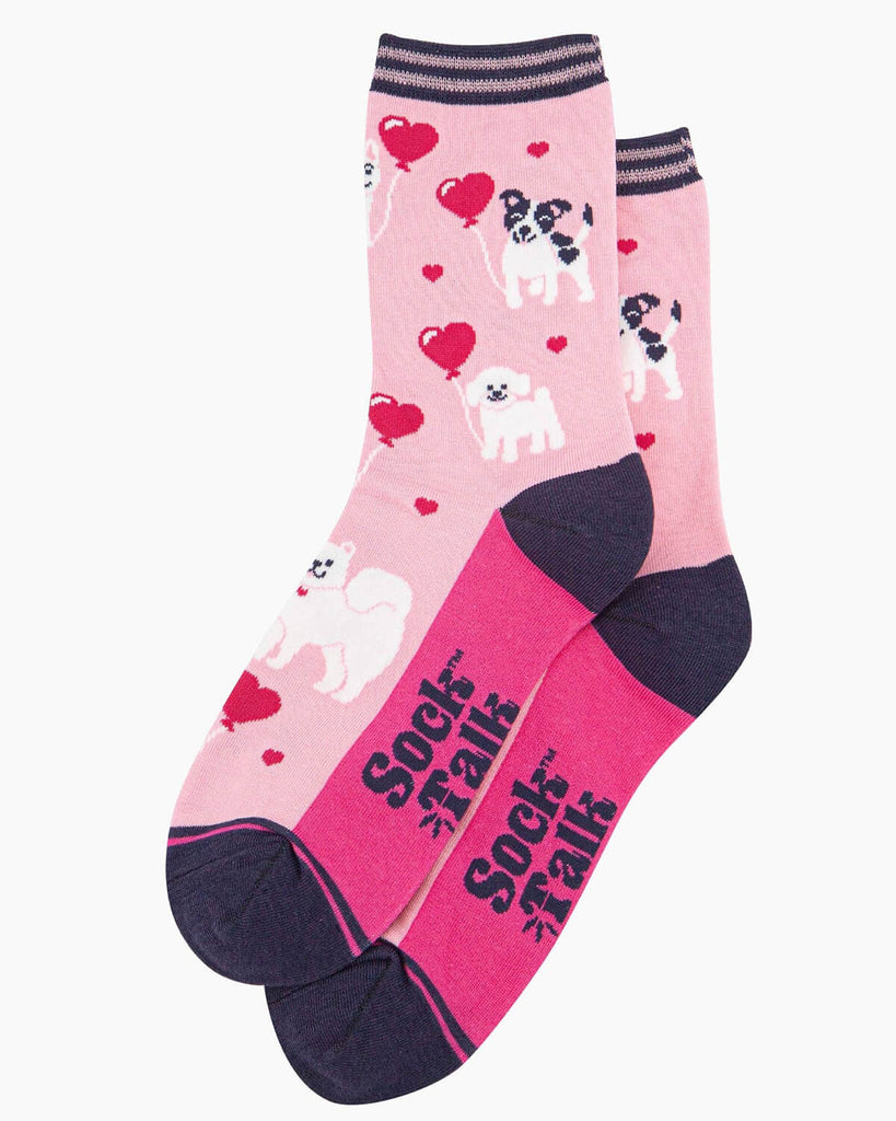 (Flat Lay of Socks): A pair of bamboo dog socks laid flat, showing the Sock Talk logo, dark purple toe and heel, and the whimsical puppy pattern.
