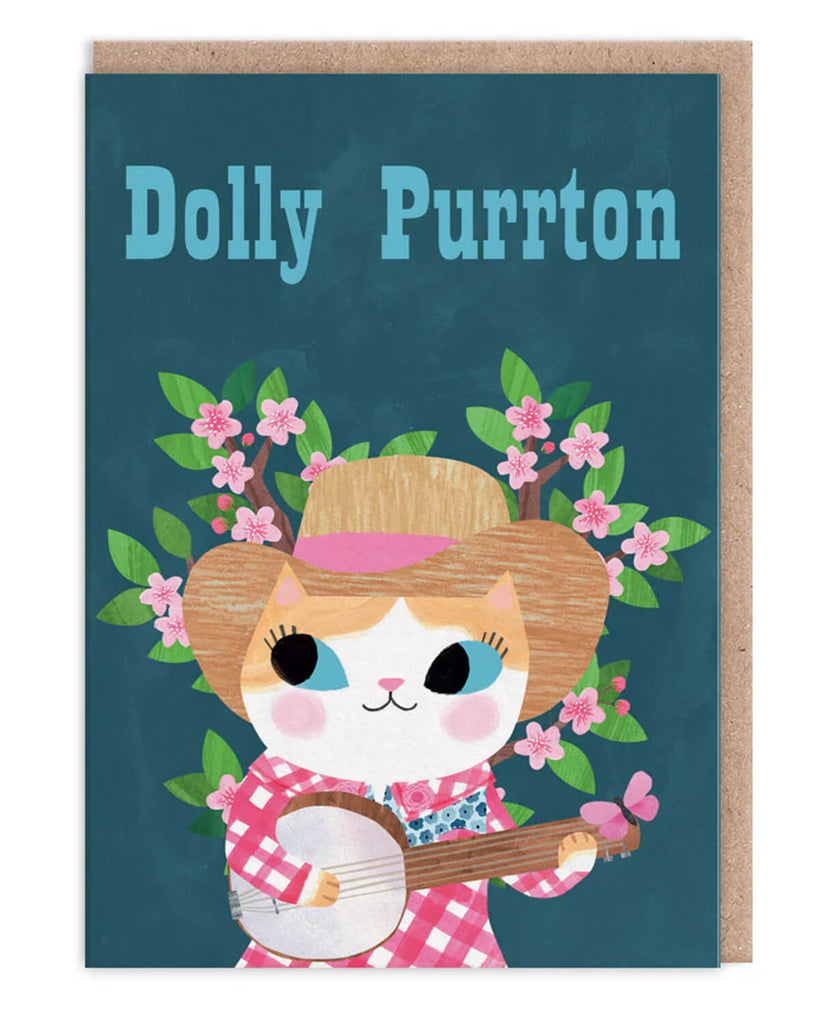 A6 greeting card featuring an illustrated cat dressed as Dolly Parton with a banjo, gingham shirt, and cowboy hat, surrounded by pink blossoms. Designed by Angie Rozelaar. Blank inside with kraft envelope.