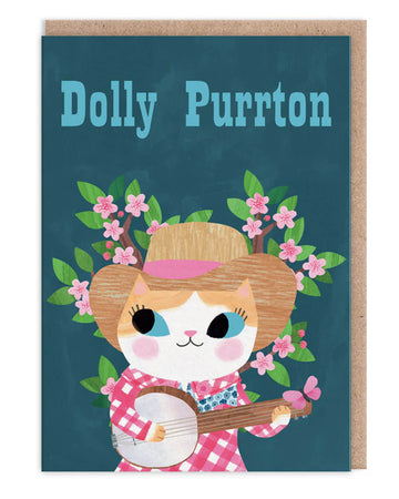 A6 greeting card featuring an illustrated cat dressed as Dolly Parton with a banjo, gingham shirt, and cowboy hat, surrounded by pink blossoms. Designed by Angie Rozelaar. Blank inside with kraft envelope.